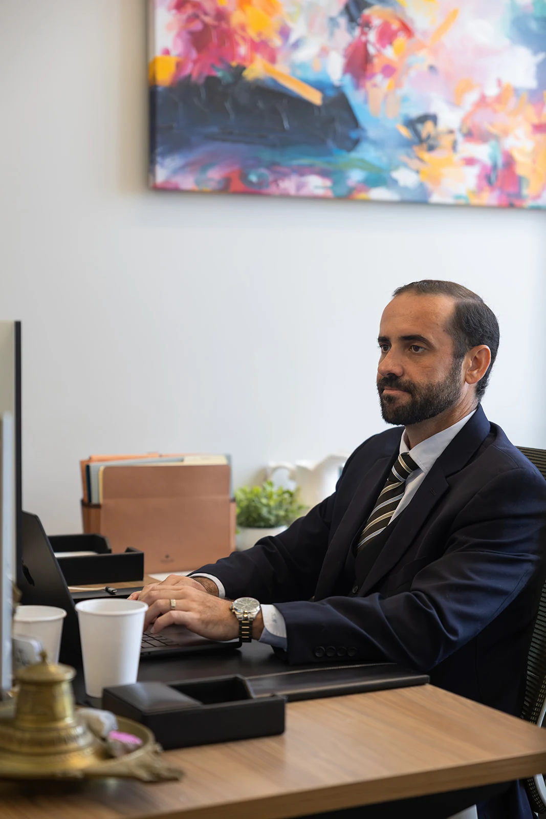 Addison Hicks typing at his desk in Orlando.